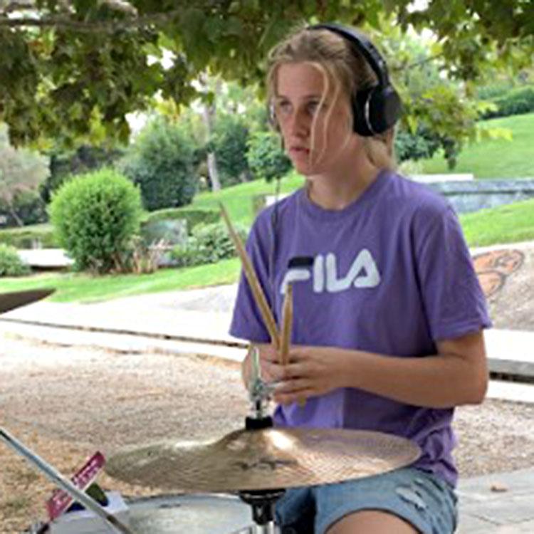 photo of Mya Cymbaluk at the drumset in a park